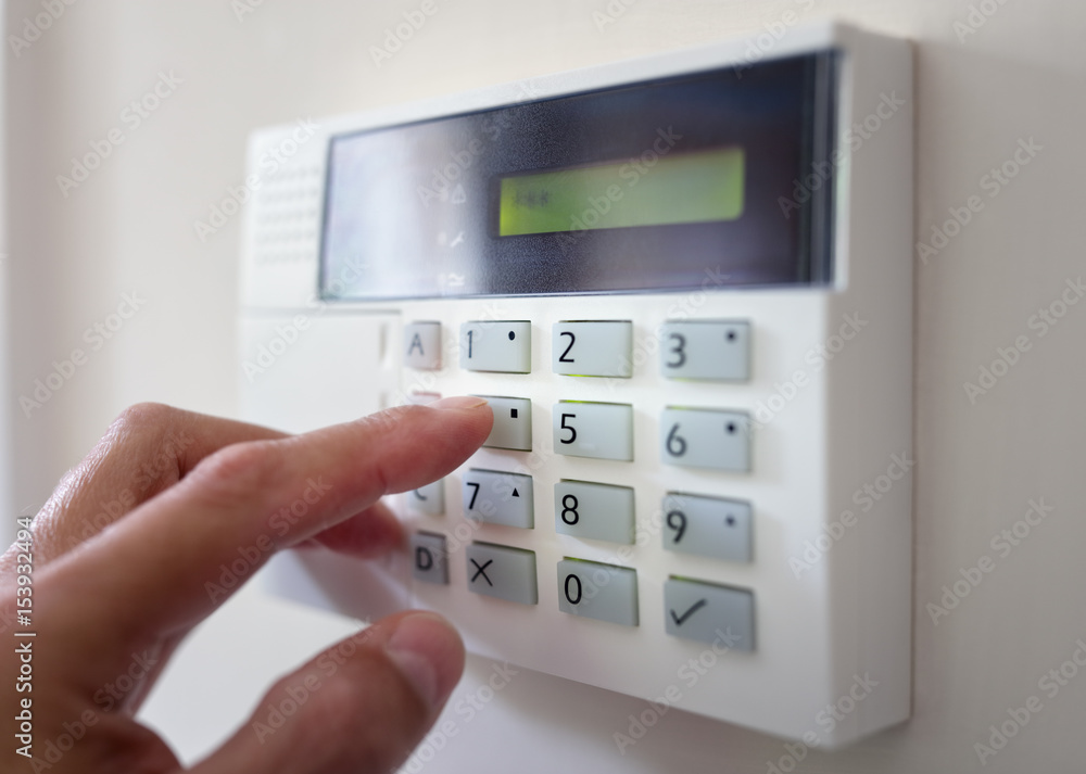 Technician installing a security alarm system